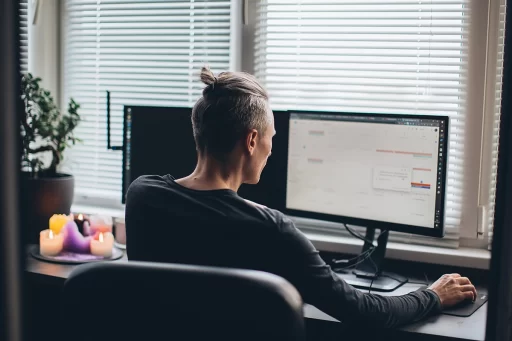 man working at desk with screens